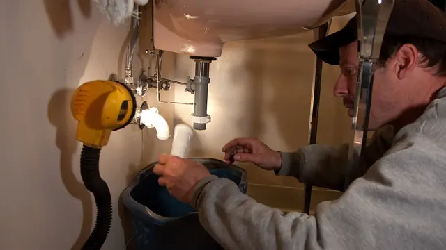 Plumbing work: Plumber at work 2010 USA