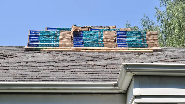 Roofing work: Shingles atop roof